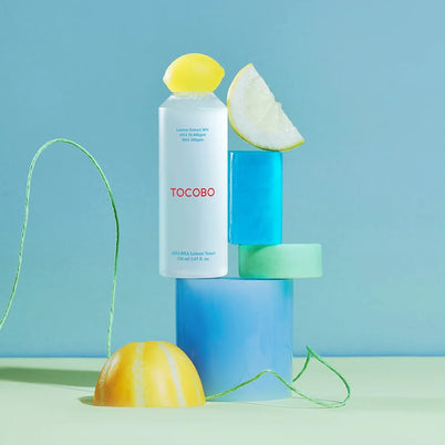 Tocobo vegan Korean skincare toner and serum displayed with citrus props for bright and fresh skincare routine